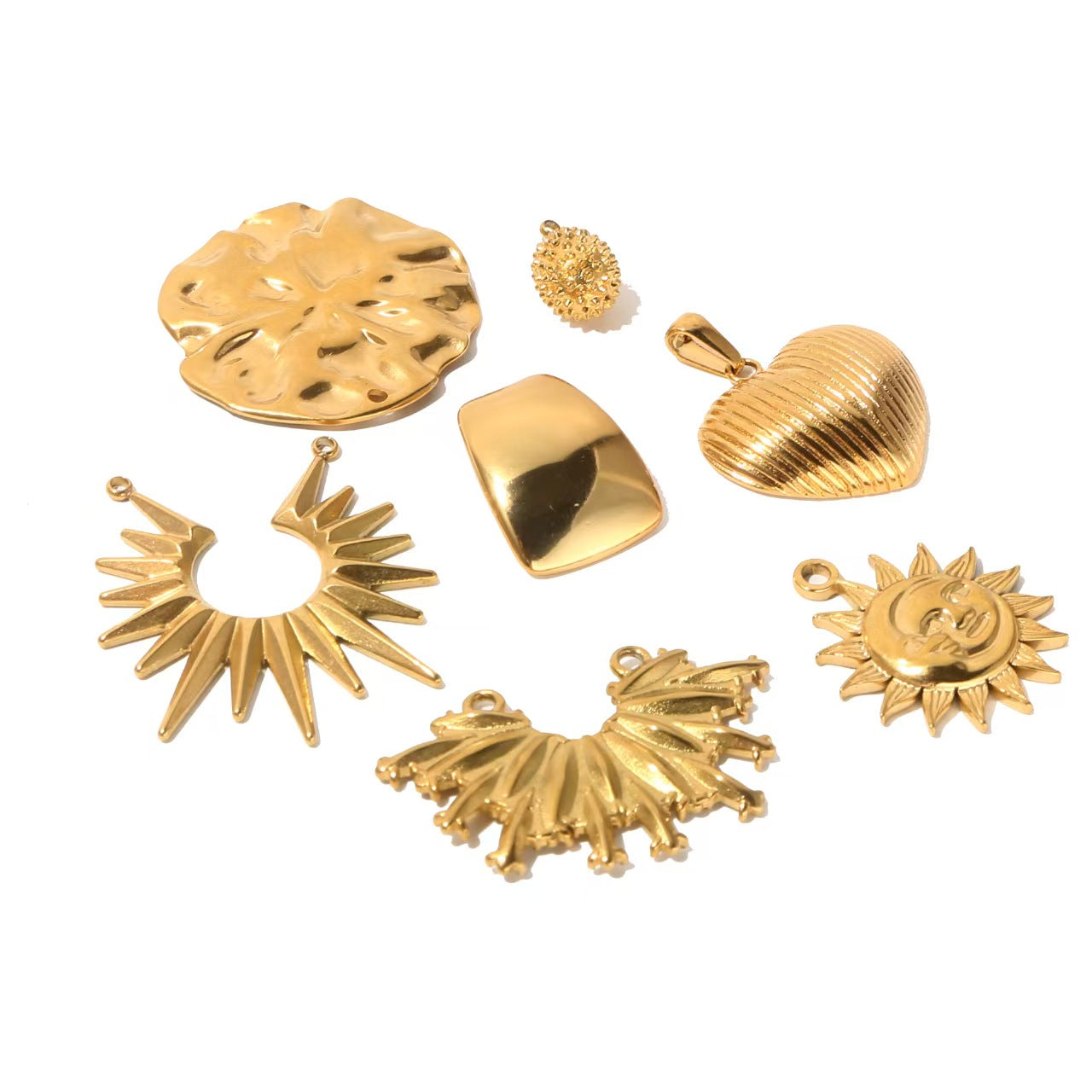 Collection of personalized gold - colored stainless - steel pendants. DIY jewelry accessories for bracelets and necklaces with multiple shapes like sun, heart, and elephant. 5 pieces in total.